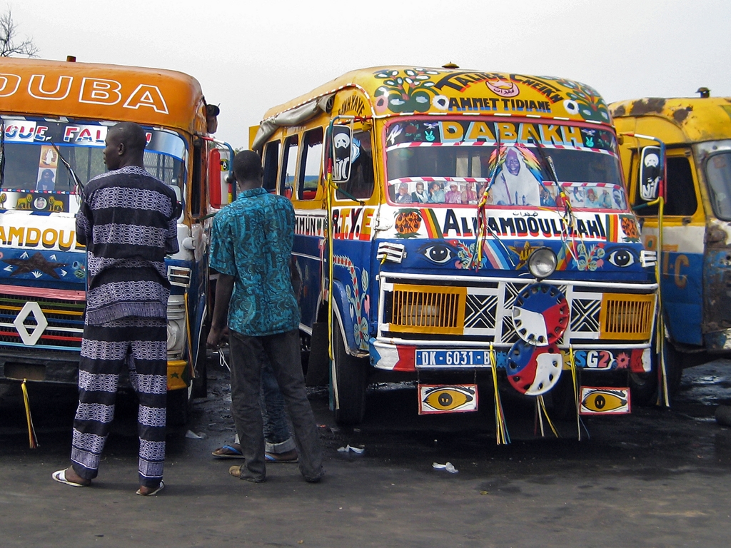 Bright colored buses certainly takes the drudgery out of bus travel in Senegal. They are called demm dikk - coming and going